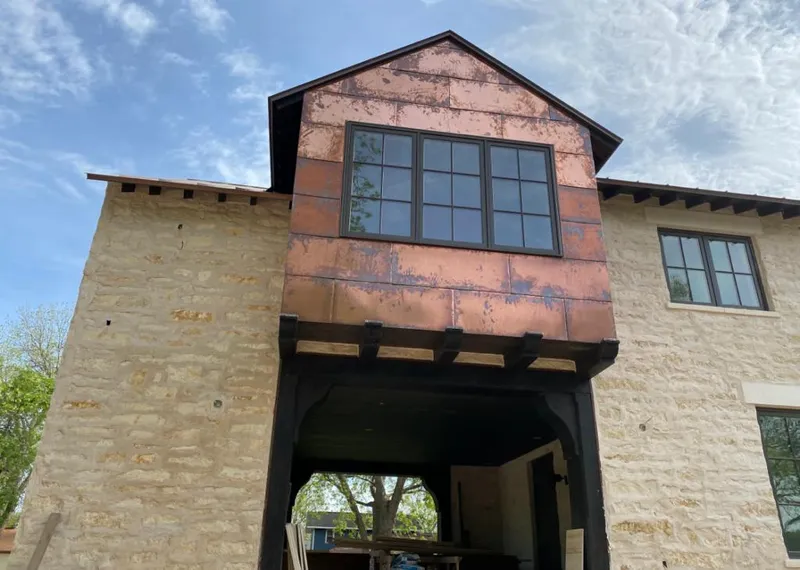 Copper metal panel facade on a stone building for Skylight Installation in West Seneca